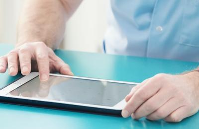 Closeup of man using a tablet